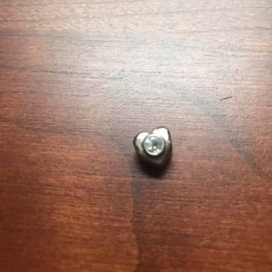 Floating necklace charm heart shaped silver with diamond stone.